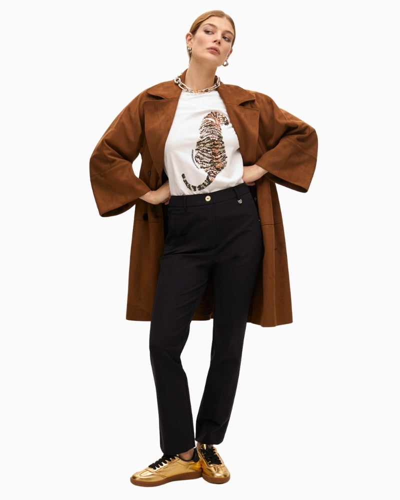 White rhinestone tiger T-shirt styled with beige trousers for a chic casual outfit