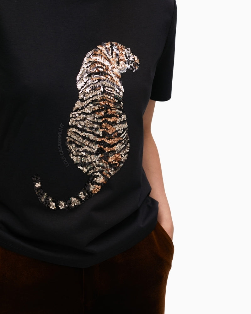 Close-up of sequin tiger design on black cotton tee