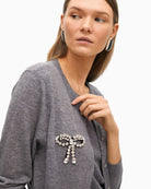 Close-up of sparkling bow embellishment and soft knit texture