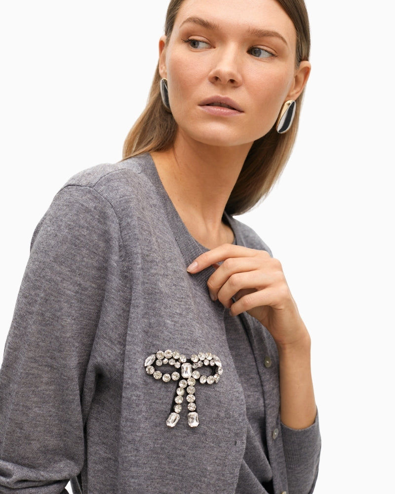 Close-up of sparkling bow embellishment and soft knit texture