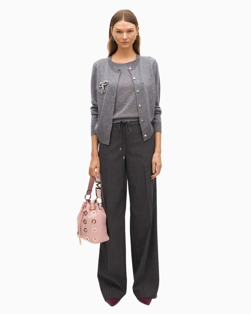 Lola Casademunt grey cardigan styled with black trousers for a smart casual look