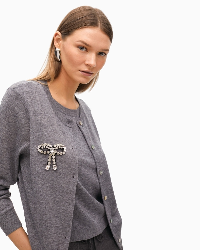Close-up of sparkling bow embellishment and soft knit texture