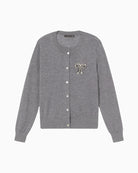 Front view of grey two-piece cardigan by Lola Casademunt with jewel bow detail