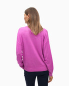 Back of ribbed cuff and V-neck detail on relaxed fit sweater