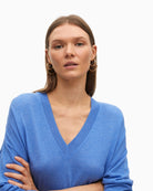 Close-up of ribbed hem and V-neckline on blue wool blend knit