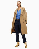 Blue V-neck jumper styled with cream trousers for a fresh, cosy look