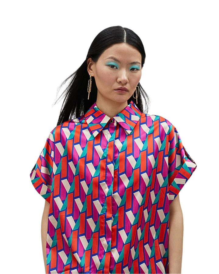 Side view of oversized logo print shirt with button-up front and collar