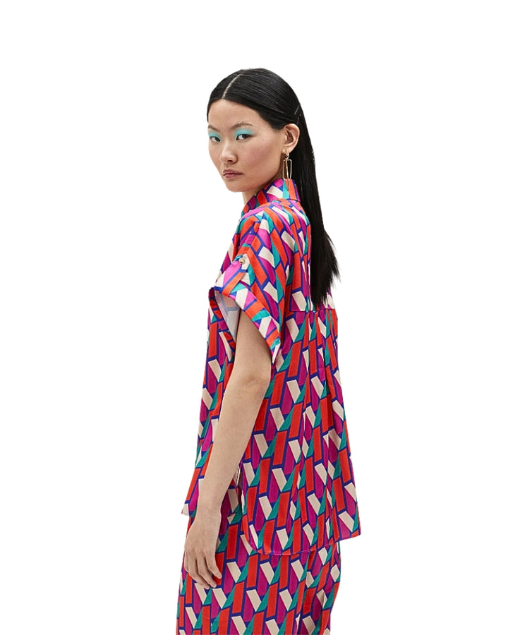 Side view of oversized logo print shirt with button-up front and collar