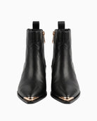 Lola Casademunt Cowboy Ankle Boot W/Studs in black front view with pointed gold-tone toe caps