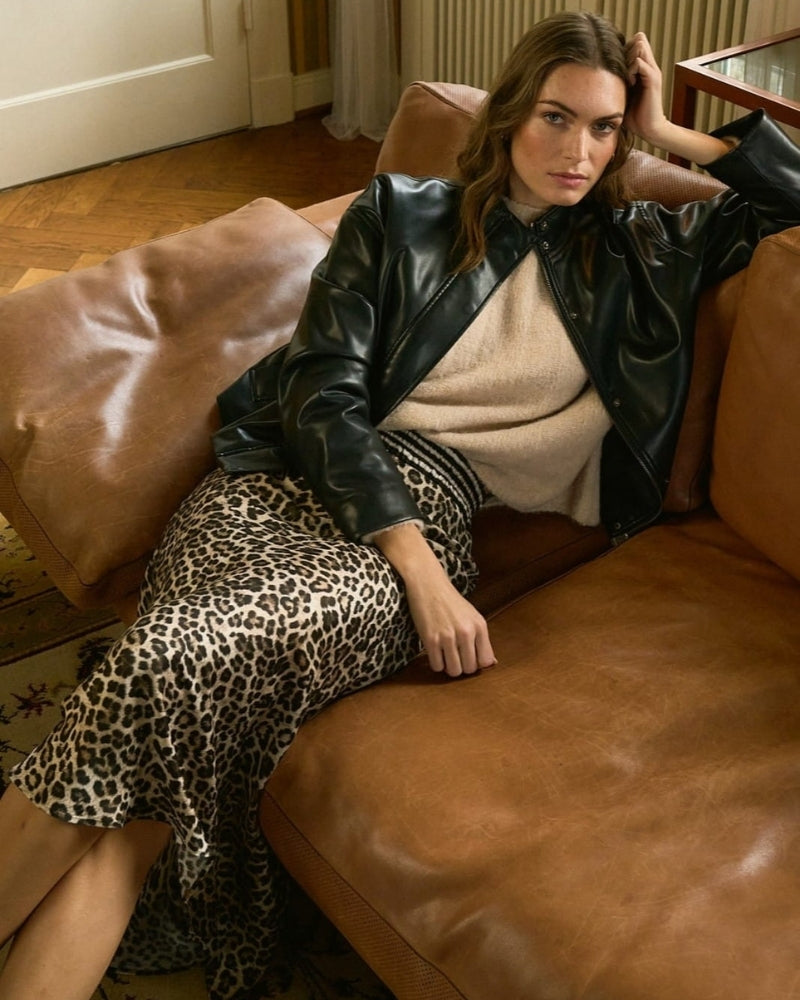 Side view of slim fit leopard print midi skirt with contrasting stripe detail