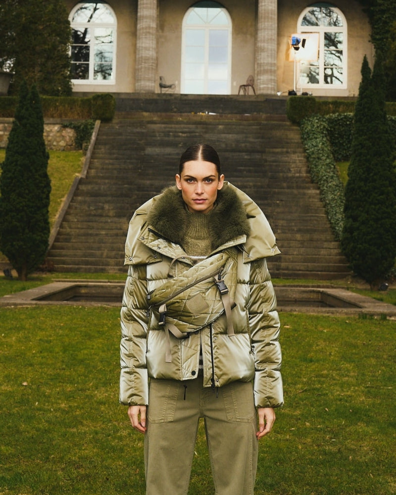 Front view of Marc Aurel shimmer puffer jacket with faux fur hood and zip pockets