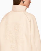 Back view of cream jacket with bold leopard head motif