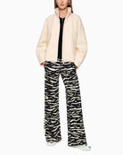 Cream statement jacket styled with jeans for a casual look