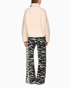 Back view of cream jacket with bold leopard head motif