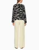 Back view of long-sleeve shirt showing relaxed cut and wide sleeves