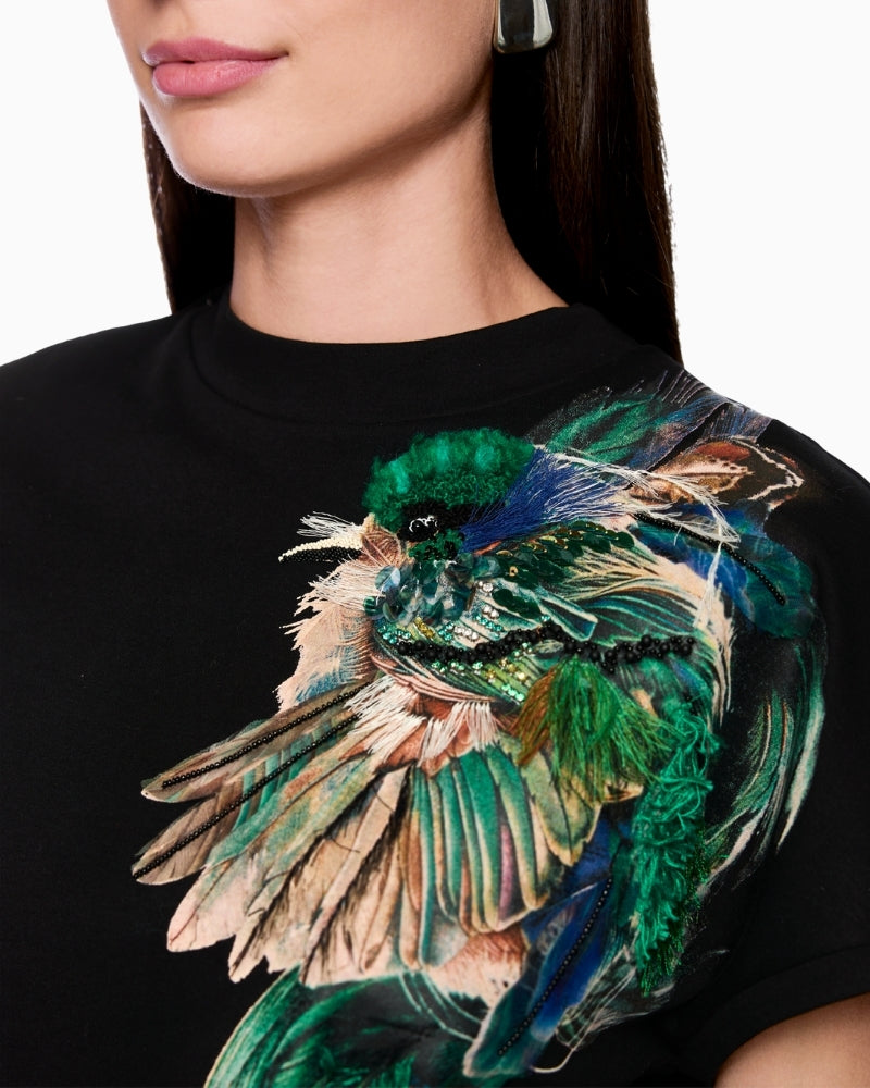 Close-up of embellished feather motif with gemstones and mini pearls