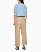 Woman wearing Marc Cain beige cotton trousers back view – Áines Boutique