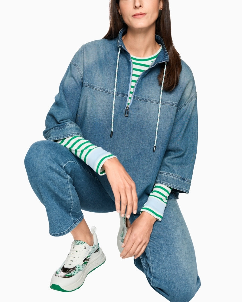 Woman wearing Marc Cain blue denim-style blouse full outfit view with matching trousers – Áines Boutique