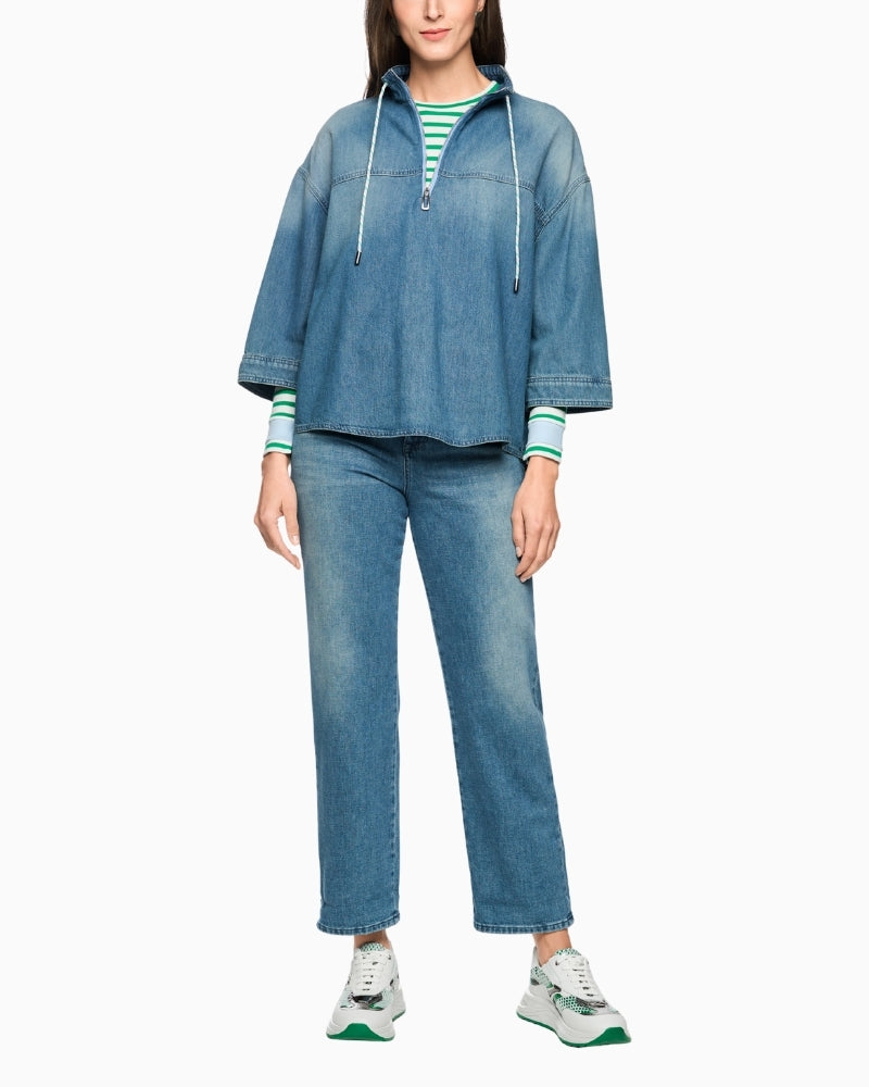 Woman wearing Marc Cain blue denim-style blouse full outfit view with matching trousers – Áines Boutique