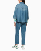 Woman wearing Marc Cain blue denim-style blouse back view showing relaxed fit – Áines Boutique