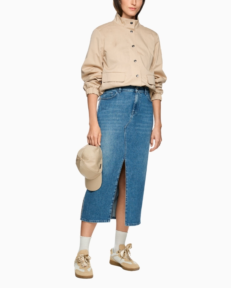 Woman wearing Marc Cain denim midi skirt styled with beige top – Áines Boutique