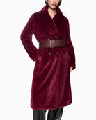 Close-up of button and pocket detail on soft maroon Marc Cain coat