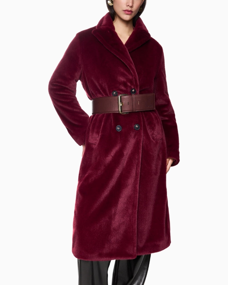 Close-up of button and pocket detail on soft maroon Marc Cain coat