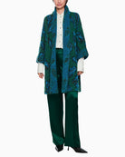 Model view of relaxed fit cape coat with draped shawl collar