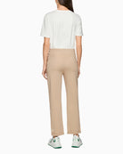Woman wearing Marc Cain beige jersey trousers back view – Áines Boutique