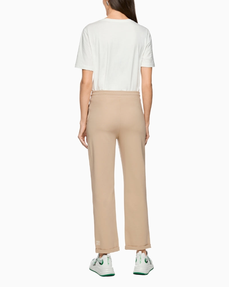 Woman wearing Marc Cain beige jersey trousers back view – Áines Boutique