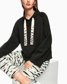 Relaxed fit jumper in black cotton blend with elegant neckline detail