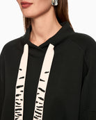 Close-up of bead appliqué detail on black sweatshirt collar