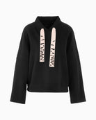 Front view of loose black jumper with wide sleeves and soft finish