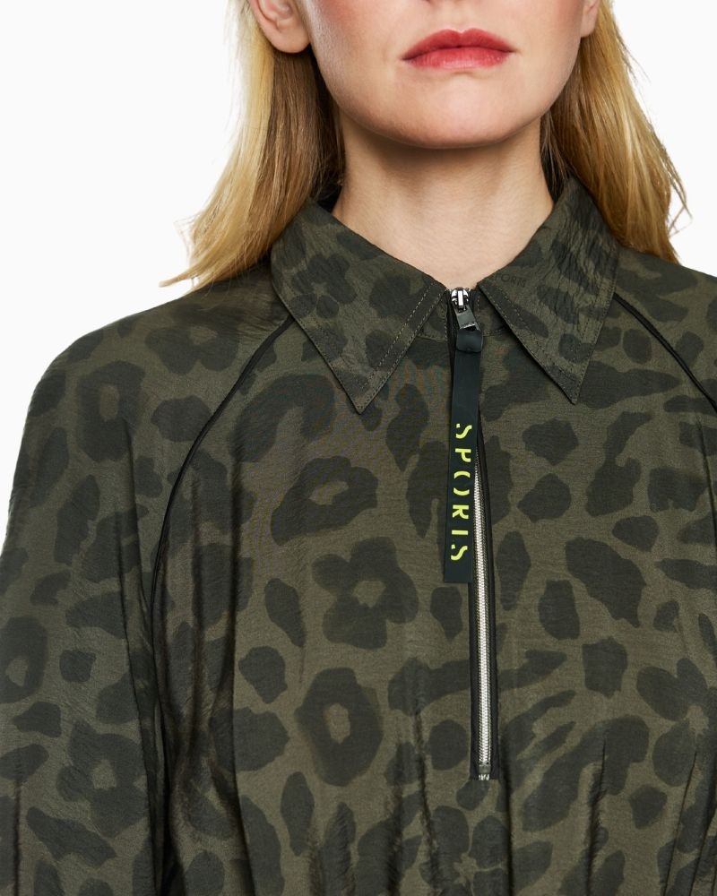 Close up of Marc Cain olive maxi dress with zip neckline, patch pockets and drawstring waist