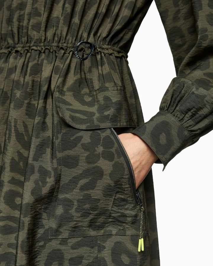 Close up of Marc Cain olive maxi dress with zip neckline, patch pockets and drawstring waist