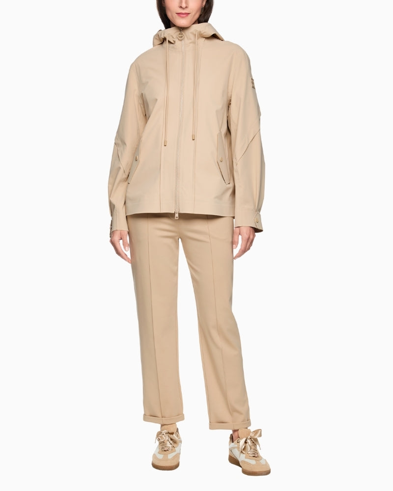 Woman wearing Marc Cain beige outdoor jacket full length – Áines Boutique
