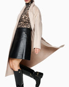 Front view of unlined Marc Cain coat showing button closure and patch pockets
