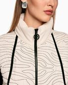 Close-up of wave quilting and high stand-up collar in cream vest