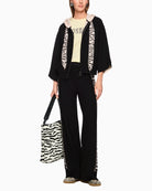 Rethink Together black cardigan styled with neutral trousers