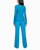 Back view of body-hugging wool jumper with sleeve slits and logo tag