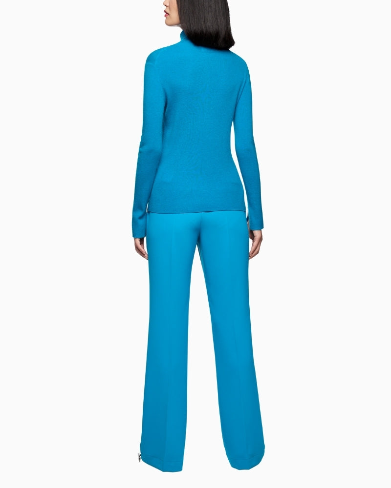 Back view of body-hugging wool jumper with sleeve slits and logo tag