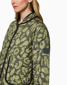 Close up of Reversible quilted jacket by Marc Cain in olive with leopard print side