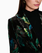 Close-up of feather-print velvet fabric with single button fastening