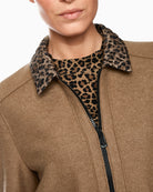 Close-up of quilted patch pocket and textured wool fabric