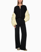 Marc Cain wide-leg jogger-style trousers styled with blouse and flats