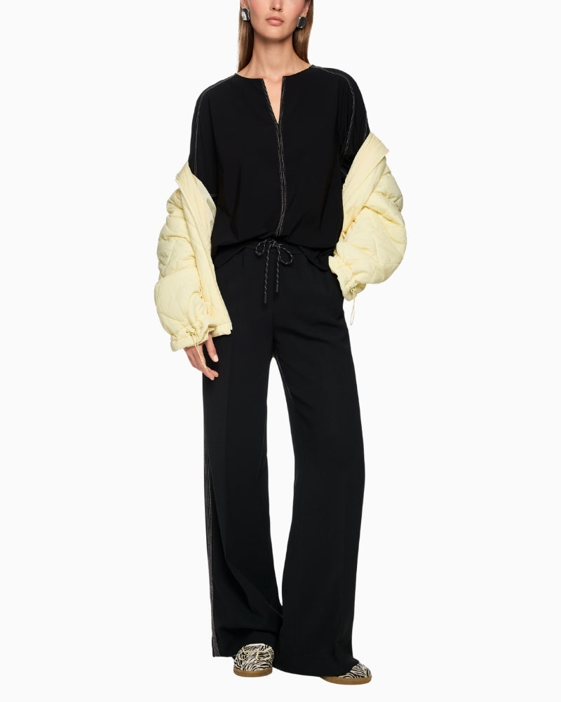 Marc Cain wide-leg jogger-style trousers styled with blouse and flats