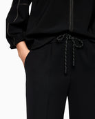Close-up of elasticated waistband with drawstring on Marc Cain trousers