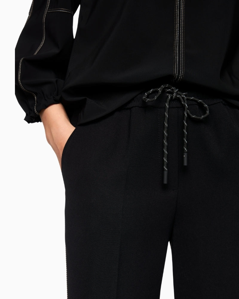 Close-up of elasticated waistband with drawstring on Marc Cain trousers