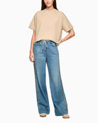 Woman wearing Marc Cain wide leg denim trousers full outfit front view – Áines Boutique