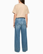Woman wearing Marc Cain blue wide leg denim trousers back view – Áines Boutique